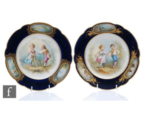 Two early 20th Century Sevres cabinet plates each decorated with children skipping and playing with a chair, both within a bl