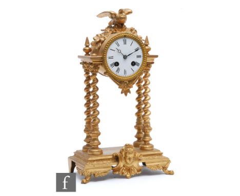 A 19th Century gilt metal portico mantle clock mounted with a bird, on a classical base, enamel floral inset pendulum, height