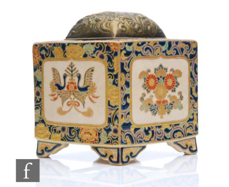 A Japanese Satsuma Meiji Period (1868-1912) lidded tea caddy, of square section raised on scroll supports, enamelled with fan