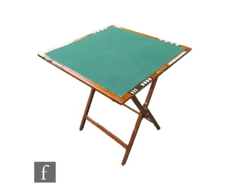 A late 19th to early 20th Century folding mahogany Bezique card playing table by W. Thornhill &amp; Co, the folding X-shaped 