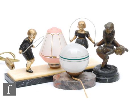 A 20th Century spelter table lamp, decorated with models of children skipping, picked out with gilt details, a conical shaped