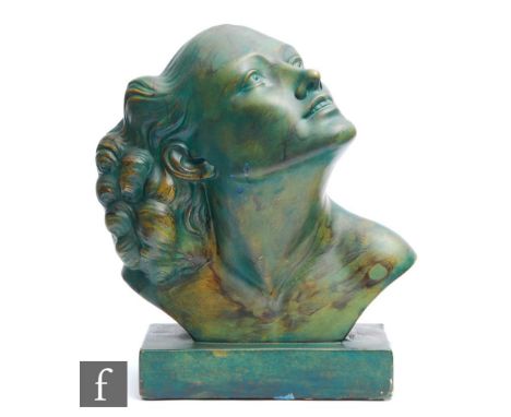 An Art Deco moulded plaster head and shoulder bust of a female in three quarter portrait gazing upwards, all in mottled green