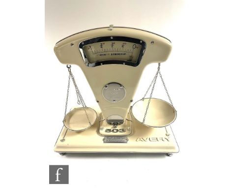 A set of 1950s cream painted enamelled Avery grocer's scales, model 505, width 48cm. 