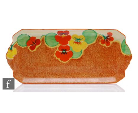 A Clarice Cliff large shape 612 sandwich tray circa 1932, hand painted in the Nasturtium pattern with stylised flowers and fo