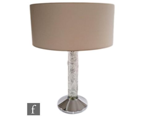 A contemporary Lalique table lamp titled Faunes, the chromed conical base mounted with a clear crystal column relief moulded 