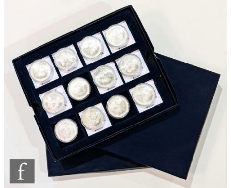 A set of American twelve one ounce silver dollars to commemorate the Titanic each with enamel backs, a Cook islands gold plat