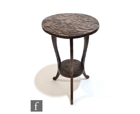 A Liberty &amp; Co Aesthetic style foliate carved softwood occasional table of circular form, raised to cabriole legs united 