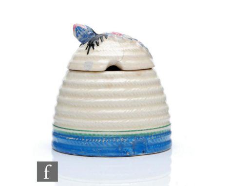 A Clarice Cliff Marguerite pattern large Beehive shape honey pot circa 1933 relief moulded with flowers and foliage to the co