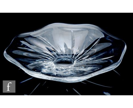 A large 20th Century Baccarat clear crystal table centre bowl of abstract wave rim form, under cut with radial mitre cut spir