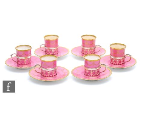 An early 20th Century Aynsley presentation cased set of six coffee cans and saucers in pink with a gilt garland pattern, the 