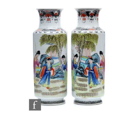 A pair of Chinese 20th Century rouleau vases, each of the white glazed bodies decorated with figures in formal fenced gardens
