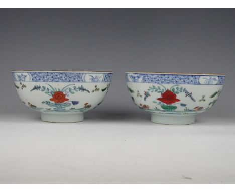 Two Chinese porcelain doucai bowls with flowers. Kangxi period 1662-1722. Height 8,5 cm. Diameter 18,5 cm. Restored.