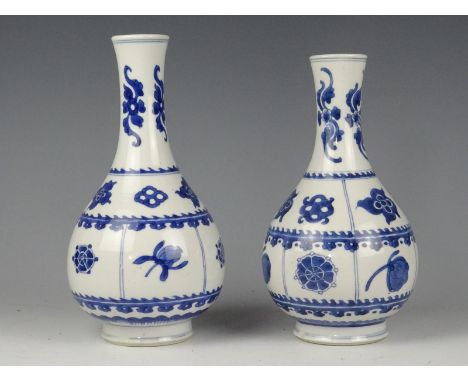 A pair chinese porcelain blue and vase with flowers. Kangxi 1662-1722. Height 21 cm. In good condition. One vase has a small 