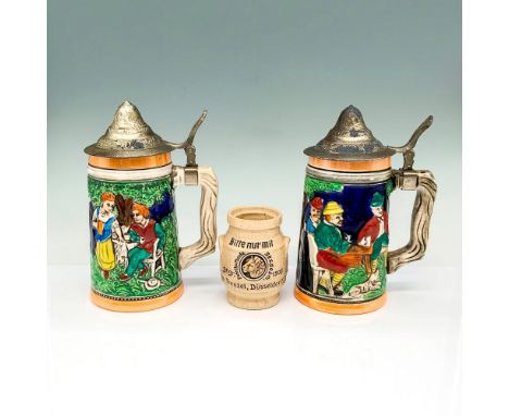Two beer steins with scenes and landmarks from Germany. They have crossed arrow stamps on their bottoms and they measure 5"L 