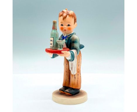 Hand painted figure of a young man serving a bottle wine. Goebel backstamp. Artist: M.I. HummelIssued: c. 1972-1979Dimensions