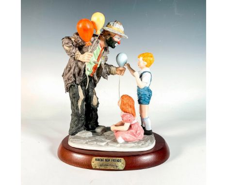 Limited edition, hand painted bisque porcelain depicting figural clown Weary Willie giving balloons to children. Rests on a w