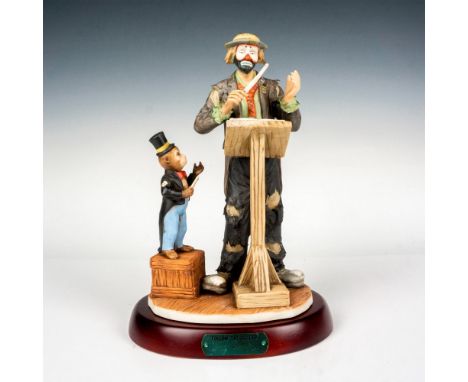 Hand painted porcelain figure of a clown and monkey conductor. Sits on a wooden base with gold-tone titled plaque. Emmett Kel