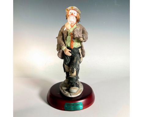 Limited edition, hand painted bisque porcelain depicting figural clown Weary Willie eating a large ball of pink cotton candy.