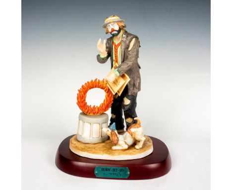 Limited edition, hand painted bisque porcelain depicting figural clown Weary Willie practicing tricks with his dog. Rests on 