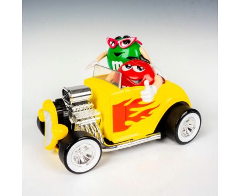 Vibrant yellow hot rod candy dispenser featuring green M&amp;M's and Red M&amp;M's riding a car. Has two openings in the trun