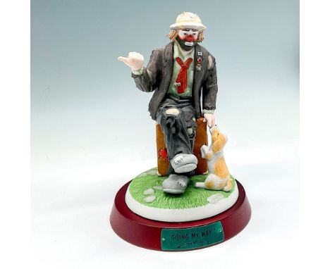 Matte finished colorful figural sitting on his suitcase talking to his dog with his thumb out. Signed and numbered 577. Flamb