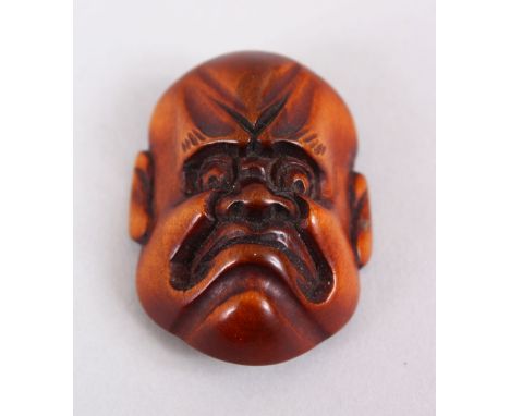A SMALLER JAPANESE MEIJI PERIOD CARVED WOODEN NETSUKE MASK OF A DOLEFUL MAN, himotoshi formed naturally to the verso, collect