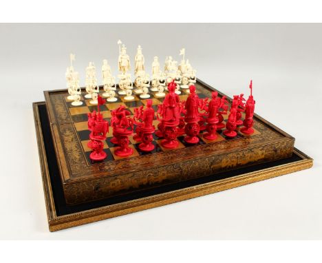 A GOOD 19TH CENTURY CHINESE CARVED &amp; STAINED IVORY CHESS SET WITH GOLD LACQUER FOLDING GAMES BOARD / BOX, the lacquer box