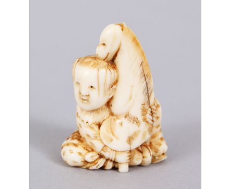 A GOOD JAPANESE MEIJI PERIOD CARVED IVORY NETSUKE OF KARAKO WITH HOBBYHORSE, The boy in a seated position holding his hobbyho