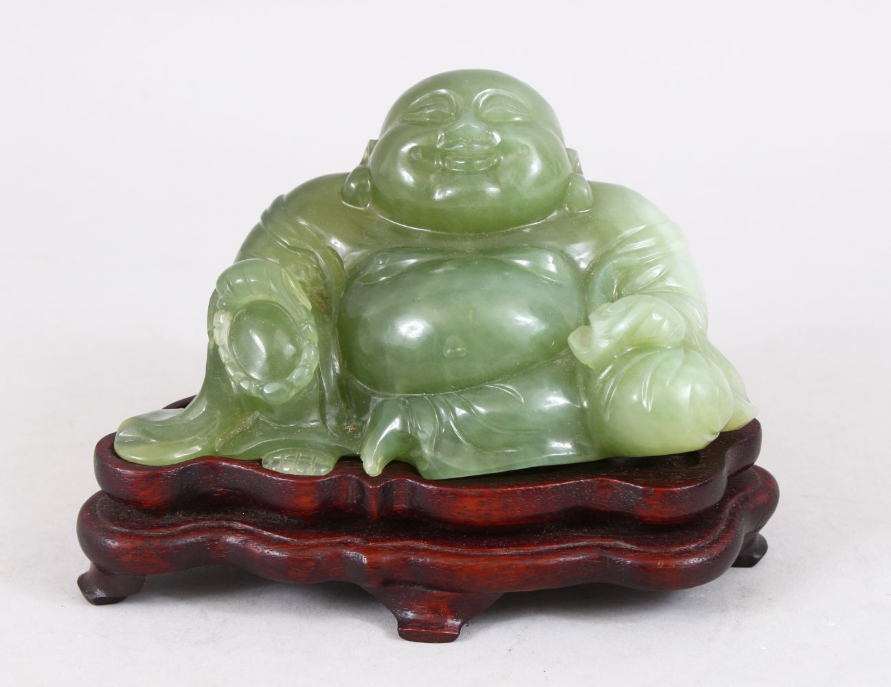 A 19TH / 20TH CENTURY CHINESE CARVED JADE FIGURE OF BUDDHA, in a seated ...