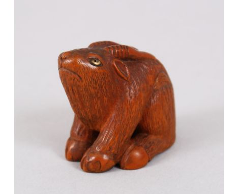 A LOVELY JAPANESE MEIJI PERIOD CARVED BOXWOOD / WOOD NETSUKE OF A GOAT, the goat in a seated position looking up, eyes inlaid