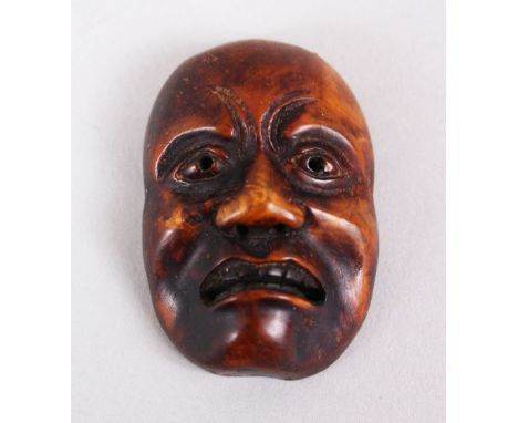 A GOOD JAPANESE MEIJI PERIOD CARVED WOODEN NETSUKE MASK OF A DOLEFUL MAN, himotoshi formed naturally to the verso, collectors