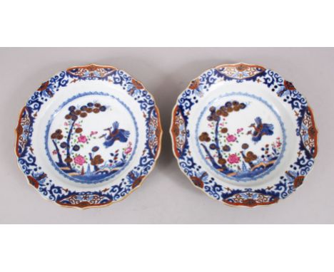 A PAIR OF QIANLONG ENAMEL DECORATED PORCELAIN SOUP PLATES, decorated with scenes of birds amongst native flora, the underside