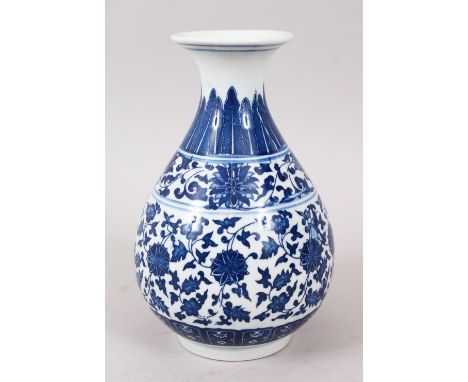 A GOOD CHINESE MING STYLE BLUE &amp; WHITE PORCELAIN BOTTLE VASE, decorated with formal scrolling foliage above a lappet styl