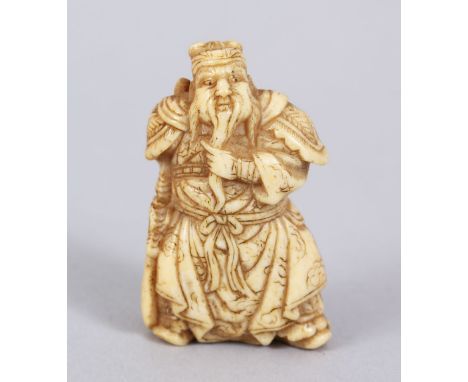 A LOVELY JAPANESE MEIJI PERIOD CARVED IVORY NETSUKE OF A KANU / CHINESE GENERAL, stood wearing traditional attire, with his h