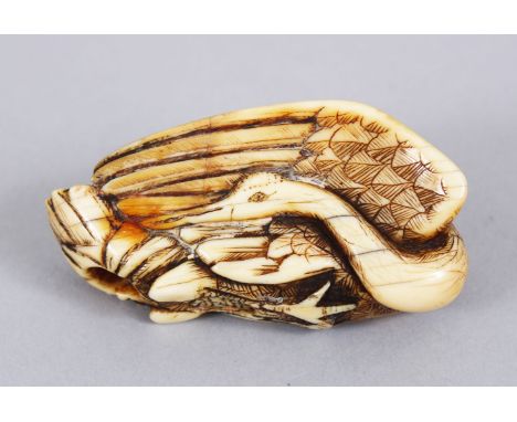 A GOOD JAPANESE EDO PERIOD CARVED IVORY NETSUKE OF A CRANE, carved and stained detailing, himotoshi formed to the wing, artis