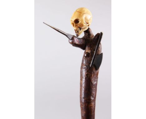 AN ORIENTAL 19TH CENTURY CARVED IVORY AND WOOD NETSUKE / FIGURE OF A SKULL -  WALKING STICK, the naturalistic formed cane mou