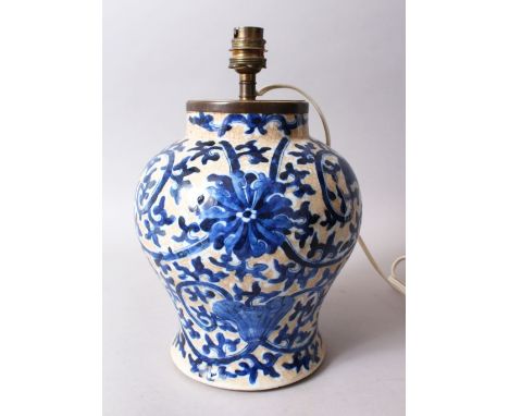 A 19TH CENTURY CHINESE BLUE &amp; WHITE CRACKLE GLAZE PORCELAIN VASE / LAMP, the body decorated on a crackle glaze biscuit gr