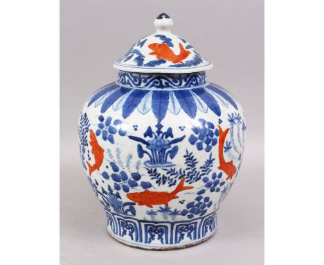 A CHINESE BLUE &amp; WHITE PORCELAIN CARP GINGER JAR AND COVER, the body of the jar decorated with iron red carp swimming aro