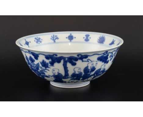 Chinese blue and white bowl decorated with boys playing in a garden, Ming marks but later, 22cm diameter, 