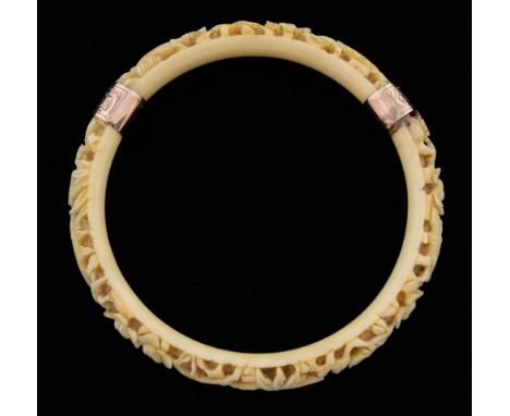 Chinese ivory bangle carved with birds, flowers and bamboo, yellow metal mounts, 10cm diameter,