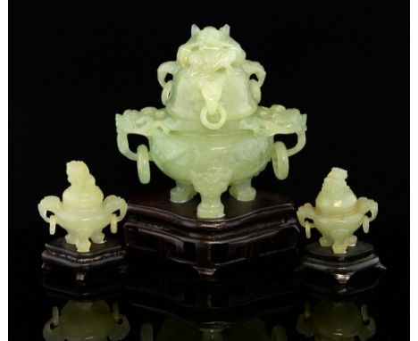 Modern Chinese green hardstone tripod censer and cover with mask ring handles on shaped supports and hardwood base, 16.5cm hi
