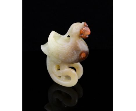 Chinese pale green/yellow jade carving of a  Phoenix, with iron inclusions, the tail curving under the feet to form the base,