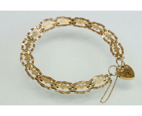 9ct yellow gold stylised gate link bracelet with textured hearts to the centre of each panel, padlock clasp with safety chain