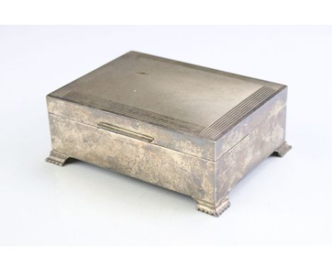 Silver cigarette box with engine turned decoration to lid, of rectangular form, raised on four bracket feet, Birmingham 1971,