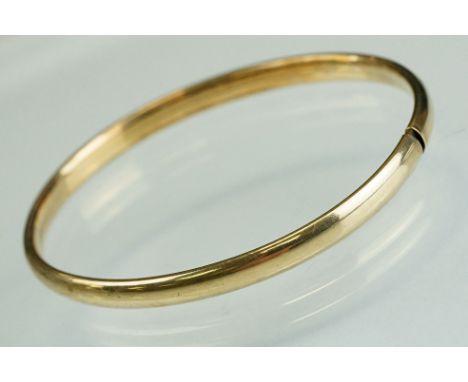 9ct yellow gold bangle, plain polished, tongue and tube fastening, width approx 5mm, interior diameter approx 17cm 