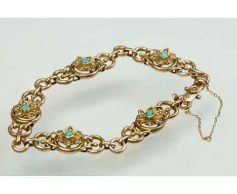 Early 20th century turquoise and seed pearl 9ct yellow gold bracelet, five flower head panels with turquoise to centre, six s