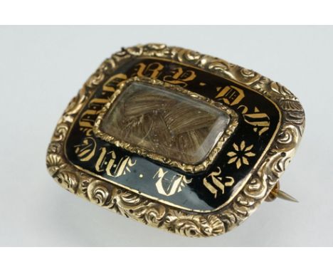 19th century enamelled mourning brooch, the black enamel with gold lettering "In Memory Of", glazed panel to centre containin