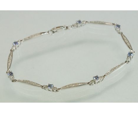 Iolite and diamond 9ct white gold bracelet, seven small round mixed cut iolite, diameter approx 2.5mm, claw set, with small r