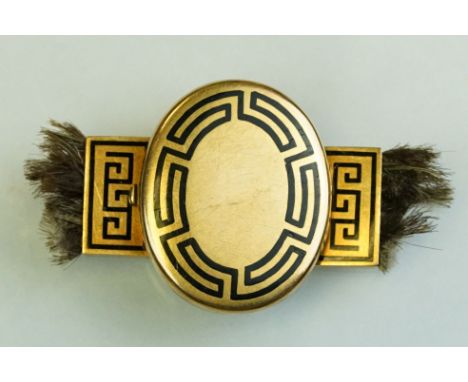19th century enamelled yellow metal locket clasp, black enamel Greek key decoration, the oval panel opening to reveal glazed 