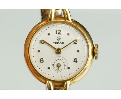 Tudor 18ct gold cased ladies watch, white enamel dial and seconds dial, gold Arabic and dot numerals and markers; gold pencil